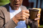 Foto på en äldre kvinna som dricker kaffe